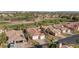 An aerial view of a single-Gathering home with a three-car garage and a well-manicured lawn in a desert community at 1223 Golf Club Dr, Laughlin, NV 89029