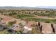An aerial view of a single-Gathering home that's situated on a golf course in a quiet, desert community at 1223 Golf Club Dr, Laughlin, NV 89029