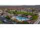 A distant aerial shot showcasing a community pool and tennis courts, with meticulously cared for landscaping at 1223 Golf Club Dr, Laughlin, NV 89029
