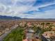 Aerial view of a community pool, tennis court, homes, and desert landscape at 1223 Golf Club Dr, Laughlin, NV 89029