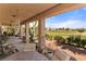 Covered patio overlooking a lush backyard and golf course with beautiful desert views at 1223 Golf Club Dr, Laughlin, NV 89029