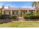 Backyard with covered patio, desert landscaping, and easy access to the green at 1223 Golf Club Dr, Laughlin, NV 89029
