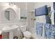 Well-lit bathroom with a pedestal sink, toilet, and enclosed shower, accented by blue patterned towels at 1223 Golf Club Dr, Laughlin, NV 89029