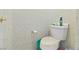 Toilet in a small bathroom with neutral wallpaper and visible cleaning supplies at 1223 Golf Club Dr, Laughlin, NV 89029