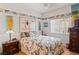 Bright bedroom with surf-themed decor, a comfortable bed, and a window with blinds at 1223 Golf Club Dr, Laughlin, NV 89029
