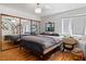 Spacious bedroom with mirrored closet doors, a ceiling fan, and ample natural light creating a pleasant retreat at 1223 Golf Club Dr, Laughlin, NV 89029
