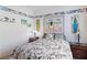 Bright bedroom featuring surfboard art, light walls, and a patterned comforter for a vibrant, beach-inspired style at 1223 Golf Club Dr, Laughlin, NV 89029