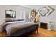Comfortable bedroom with a cozy bed, wood floors, and decorative mirrors adding depth and character at 1223 Golf Club Dr, Laughlin, NV 89029