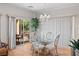 Bright dining area with a glass table, elegant chairs, and sliding doors to the outdoor area at 1223 Golf Club Dr, Laughlin, NV 89029