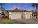 Charming home featuring a well-maintained front yard and a two-car garage, enhancing curb appeal at 1223 Golf Club Dr, Laughlin, NV 89029