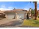 Charming single-story home features a two-car garage, tile roof, and an inviting gated front entryway at 1223 Golf Club Dr, Laughlin, NV 89029