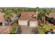 Desirable home featuring an attached three-car garage, tile roofing, mature landscaping, and a circular driveway at 1223 Golf Club Dr, Laughlin, NV 89029