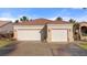 Expansive home featuring a two-car garage, tile roof, desert landscaping, and a private gated entrance at 1223 Golf Club Dr, Laughlin, NV 89029
