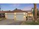Well-lit home featuring a well-maintained front yard and a two-car garage, enhancing curb appeal at 1223 Golf Club Dr, Laughlin, NV 89029