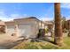Charming single-story home features a two-car garage, tile roof, and an inviting gated front entryway at 1223 Golf Club Dr, Laughlin, NV 89029