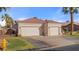 Expansive home featuring a two-car garage, tile roof, desert landscaping, and a private gated entrance at 1223 Golf Club Dr, Laughlin, NV 89029