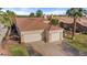Expansive home featuring a two-car garage, tile roof, desert landscaping, and a private gated entrance at 1223 Golf Club Dr, Laughlin, NV 89029