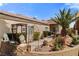 Attractive front yard with lush greenery, decorative lion statues, and a charming gated entrance at 1223 Golf Club Dr, Laughlin, NV 89029