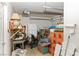 A cluttered garage space with storage, shelving, and a garage door opening at 1223 Golf Club Dr, Laughlin, NV 89029