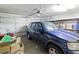 Organized garage featuring a blue SUV, storage shelves, and ample space for parking and storage at 1223 Golf Club Dr, Laughlin, NV 89029