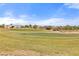 Scenic view of a well-maintained golf course with lush green grass under a bright blue sky with scattered clouds at 1223 Golf Club Dr, Laughlin, NV 89029