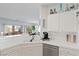 Kitchen with white cabinets, tile countertops, stainless steel appliances, and sink overlooking a patio at 1223 Golf Club Dr, Laughlin, NV 89029