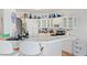 Bright kitchen with white cabinets, tile countertops, stainless steel appliances, and white tile backsplash at 1223 Golf Club Dr, Laughlin, NV 89029