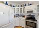 Modern kitchen with stainless steel appliances, ample white cabinets, and tile countertops for functionality at 1223 Golf Club Dr, Laughlin, NV 89029