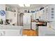 Bright kitchen boasts ample white cabinets, tile countertops, modern appliances, and wood-look tile flooring at 1223 Golf Club Dr, Laughlin, NV 89029