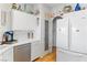 Modern kitchen features white cabinets, tile countertops, stainless steel appliances, and wood-look tile flooring at 1223 Golf Club Dr, Laughlin, NV 89029