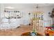 Bright kitchen features tile floors, white cabinetry, modern appliances, and a breakfast bar with barstool seating at 1223 Golf Club Dr, Laughlin, NV 89029