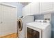 Efficient laundry room featuring a modern washer and dryer set with upper cabinets for storage at 1223 Golf Club Dr, Laughlin, NV 89029