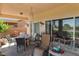 Cozy covered patio with a dining set, comfortable lounge chairs, and outdoor decor at 1223 Golf Club Dr, Laughlin, NV 89029