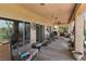 Extended covered patio with seating, potted plants, wind chimes, and a view of the golf course at 1223 Golf Club Dr, Laughlin, NV 89029