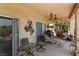 Relaxing covered patio featuring outdoor seating, a grill, and tranquil views of the backyard and golf course at 1223 Golf Club Dr, Laughlin, NV 89029