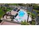 This aerial view showcases the community pool, solar panels, and an abundance of lounge seating at 1223 Golf Club Dr, Laughlin, NV 89029