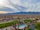 Community pool with a tennis court, desert landscaping, and mountain views at 1223 Golf Club Dr, Laughlin, NV 89029