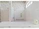 Bathroom showcasing a modern shower with sleek fixtures, built-in shelves, and grab bar at 1223 Golf Club Dr, Laughlin, NV 89029