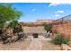 Backyard featuring a sunken patio with desert landscaping and mountain views at 1561 Campfire Ln, Mesquite, NV 89034