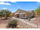 Exterior shot of the home with desert landscaping and paved walkway at 1561 Campfire Ln, Mesquite, NV 89034