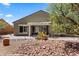 This backyard features desert landscaping, a covered patio area, and desert plants at 1561 Campfire Ln, Mesquite, NV 89034
