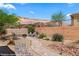 Outdoor patio with desert landscaping, mature shrubbery, and walkway at 1561 Campfire Ln, Mesquite, NV 89034