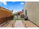 Low maintenance side yard with artificial turf, bench and walkway at 1561 Campfire Ln, Mesquite, NV 89034