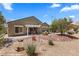 Backyard featuring a covered patio with desert landscaping, desert plants, and mountain views at 1561 Campfire Ln, Mesquite, NV 89034