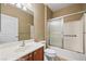 Cozy bathroom with a combined shower and tub, sliding glass door, vanity sink, and neutral colors at 1561 Campfire Ln, Mesquite, NV 89034