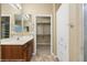 Bright bathroom with dual sinks, tile floor, and access to a walk-in closet at 1561 Campfire Ln, Mesquite, NV 89034