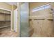 Shower with tile surround, bench, window, and rainfall shower head at 1561 Campfire Ln, Mesquite, NV 89034