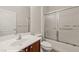 Bathroom featuring vanity sink, tiled floors and a shower with a glass sliding door at 1561 Campfire Ln, Mesquite, NV 89034