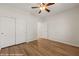 Bedroom with hardwood floors, ceiling fan and closet with sliding doors at 1561 Campfire Ln, Mesquite, NV 89034