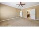 Spacious bedroom with neutral carpet, ceiling fan, and en suite bathroom at 1561 Campfire Ln, Mesquite, NV 89034